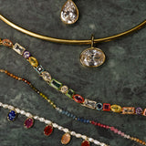 Collection of necklaces with various pendants on a dark surface