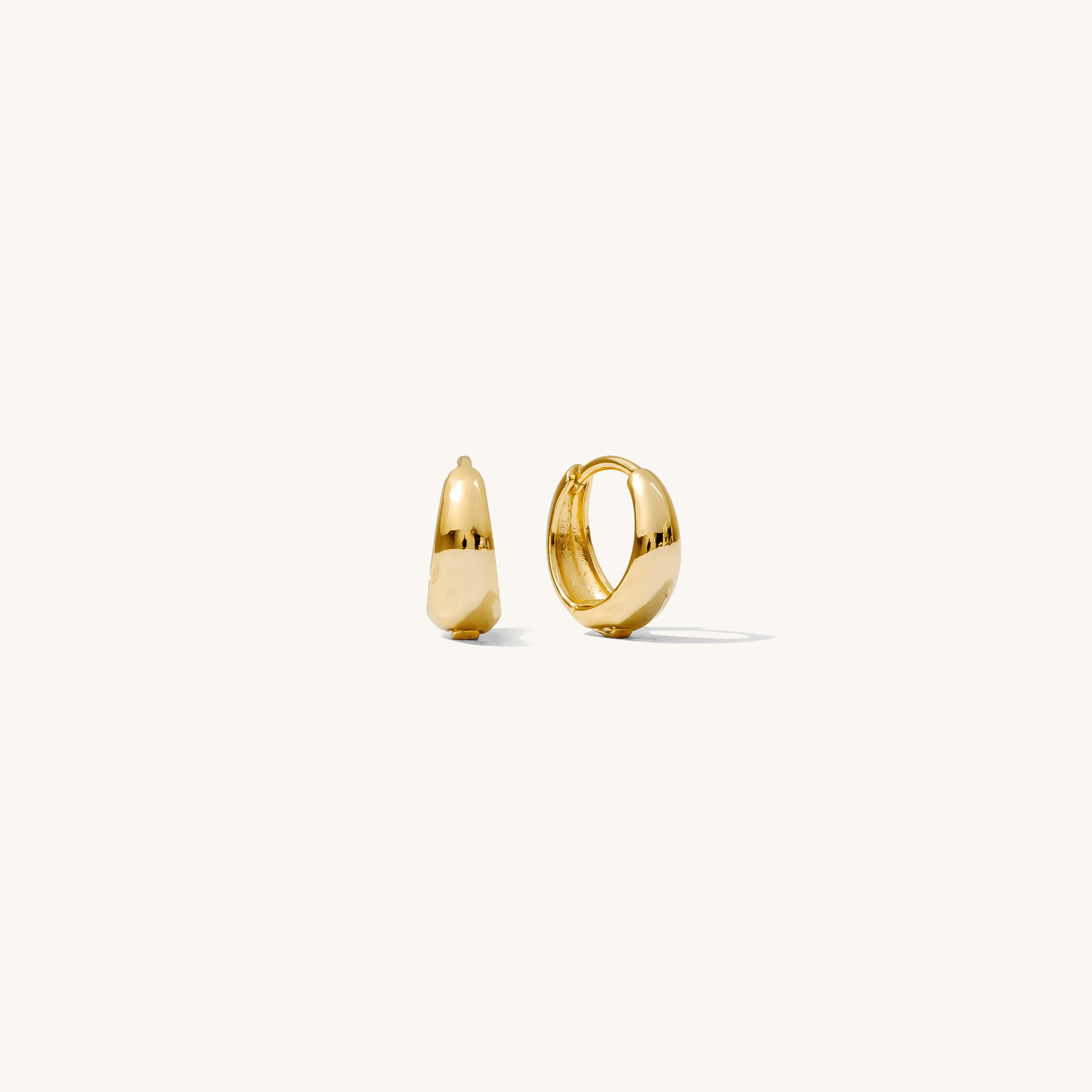 Close up of gold hoop earrings on a white background 