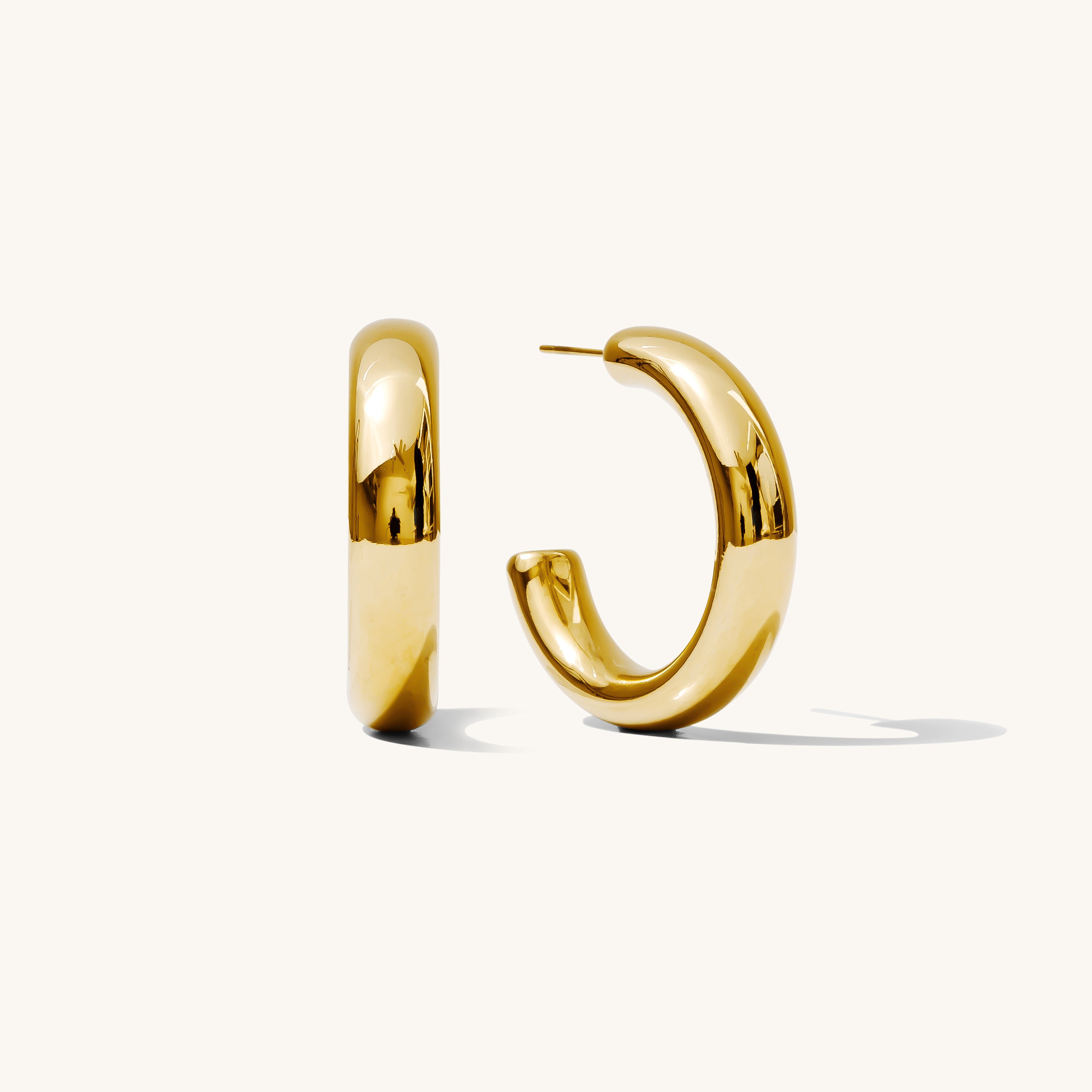 Close up of gold hoops on a white background 