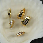 Gold rings with gemstones on a white shell