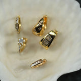 Gold rings with gemstones on a white shell