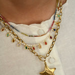 Necklace with star pendant and colorful beads on a white background