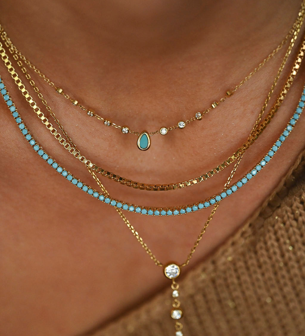 turquoise necklace on model with turquoise tennis necklace