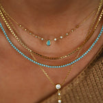 turquoise necklace on model with turquoise tennis necklace
