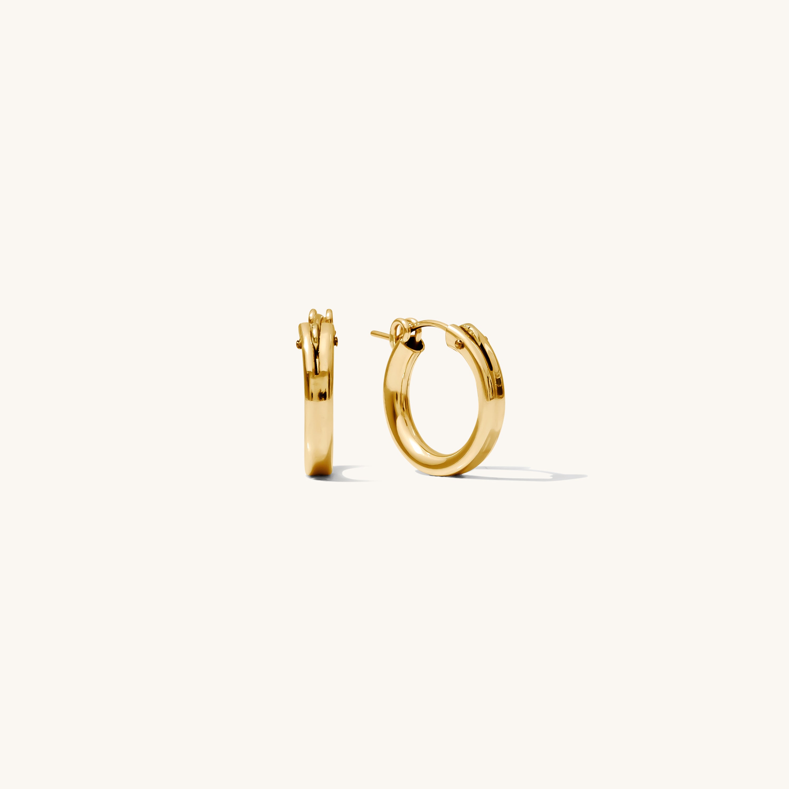 Close up of gold hoop earrings on a white background 