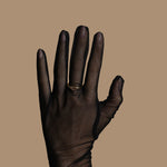 Black glove on a beige background