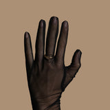 Black glove on a beige background
