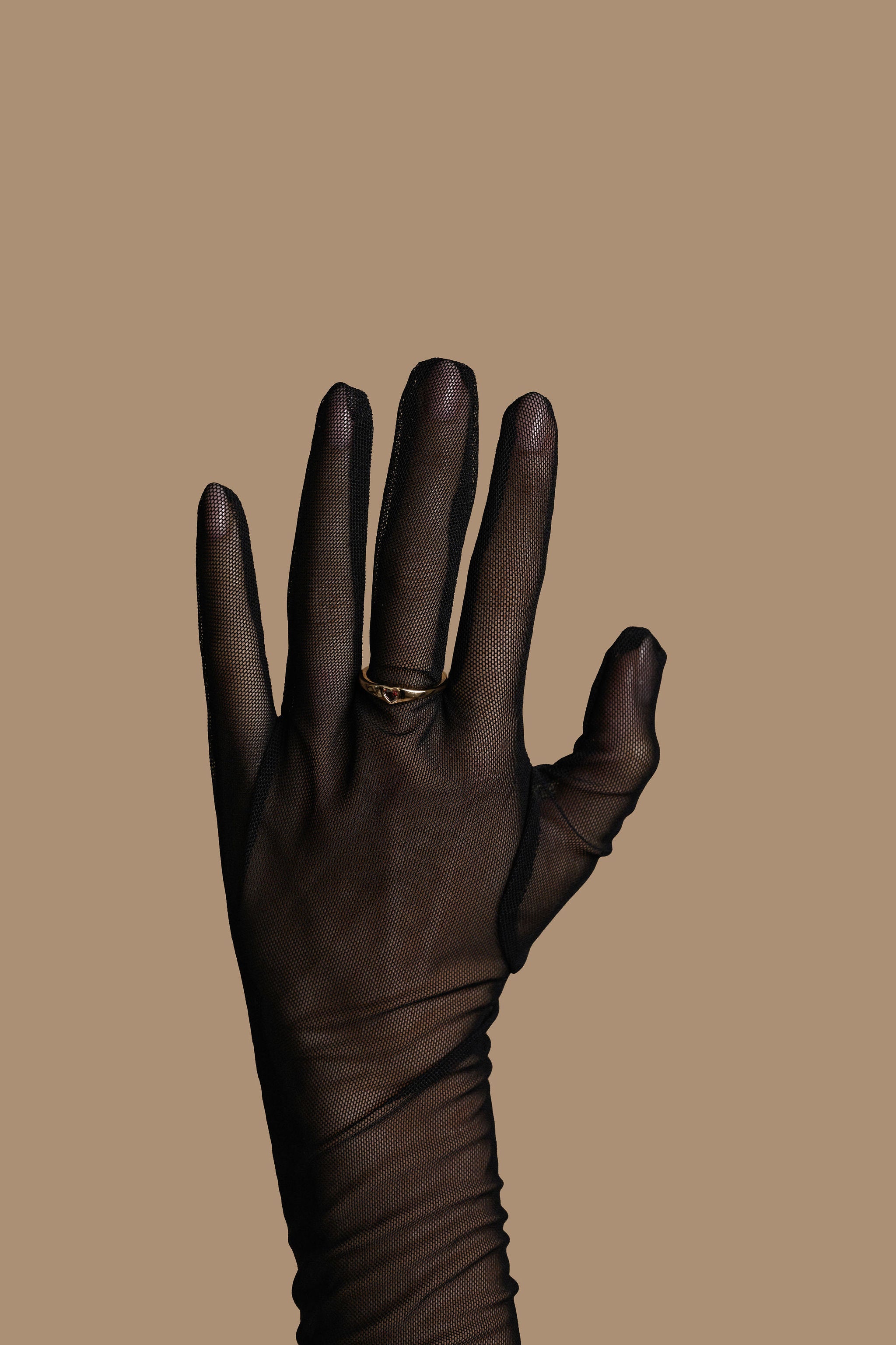 Black glove on a beige background