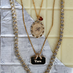 Gold necklaces with decorative elements on a textured surface