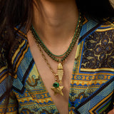Model wearing the olive Pez gemstone necklace with a vintage fish charm