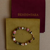 Beaded bracelet on a 'Beads by Tara' card with a maroon backing
