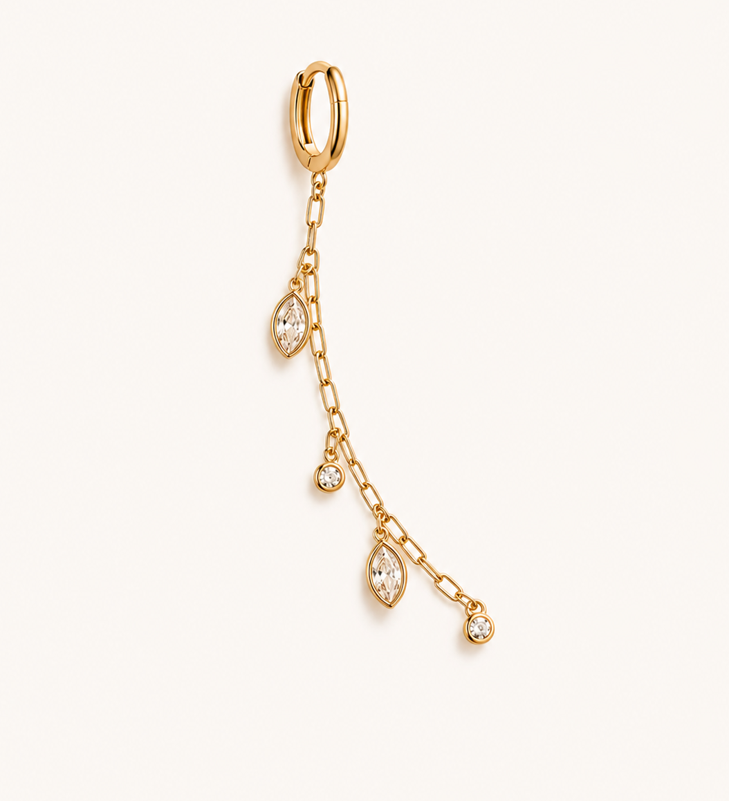 Gold earring with chain and teardrop-shaped gemstones on a white background