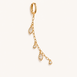 Gold earring with chain and teardrop-shaped gemstones on a white background