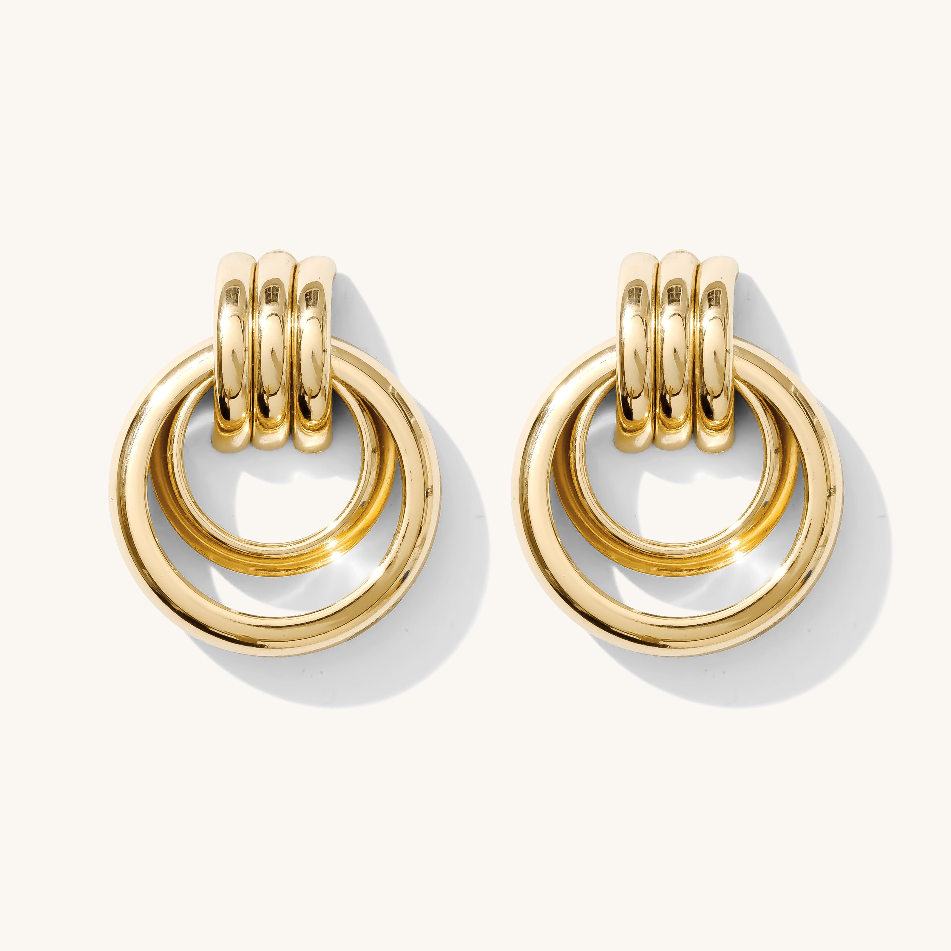 Close up of gold earrings on a white background