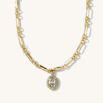 Gold chain necklace with a diamond pendant on a white background