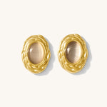Pair of gold earrings on a white background