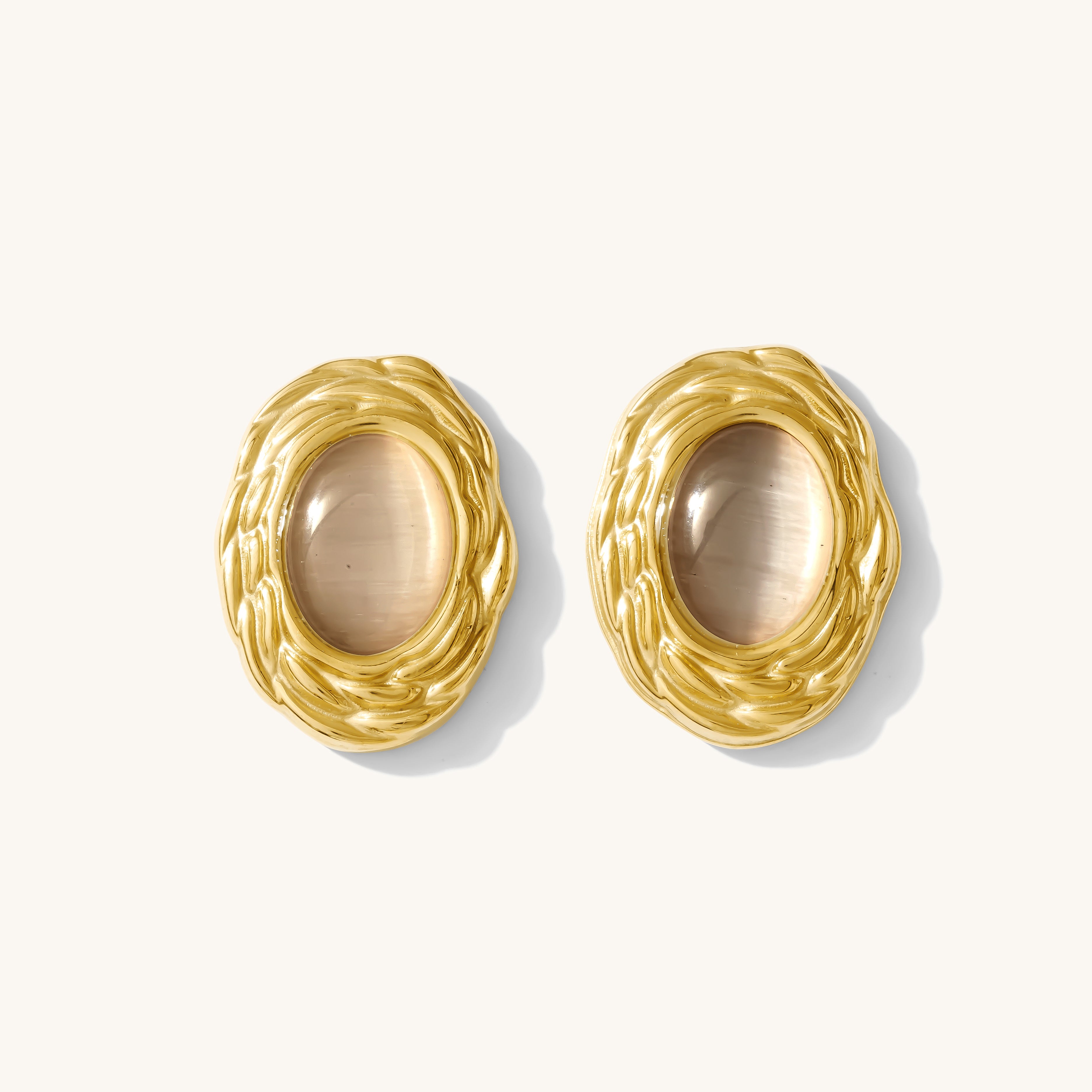 Pair of gold earrings on a white background
