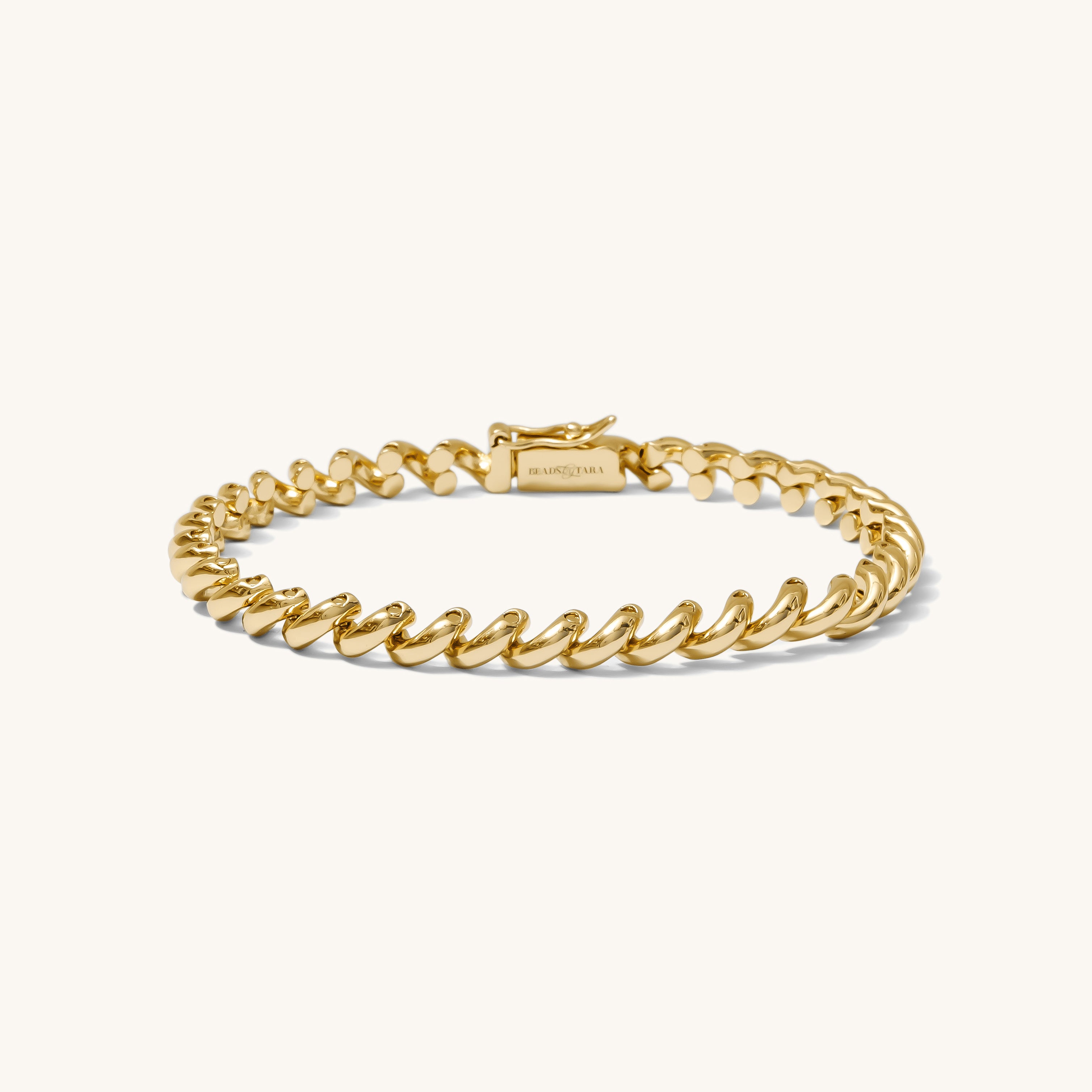 Gold bracelet on a white background