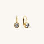 Gold earrings with clear gemstones on a white background