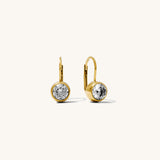 Gold earrings with clear gemstones on a white background