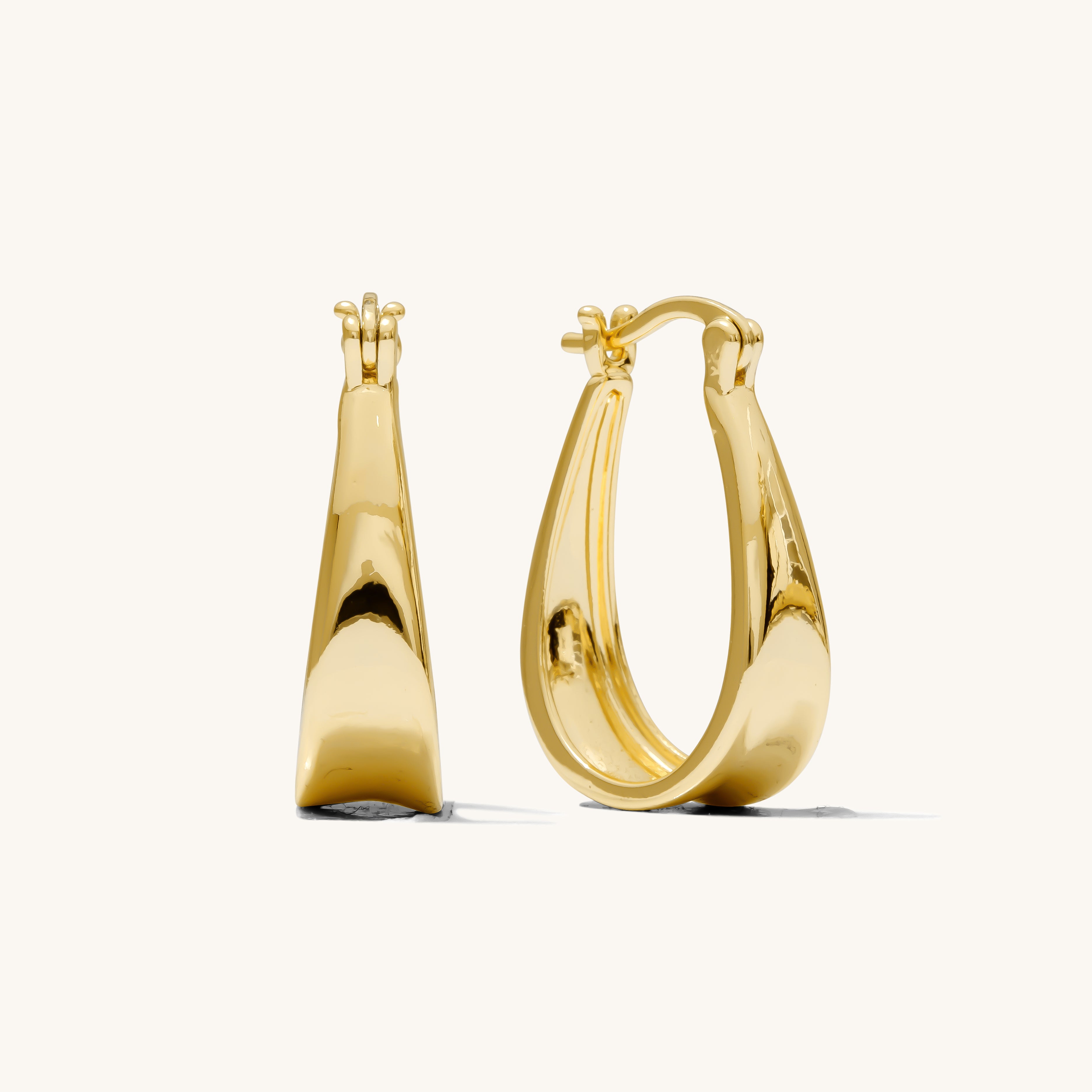Close up of gold hoop earrings on a white background 