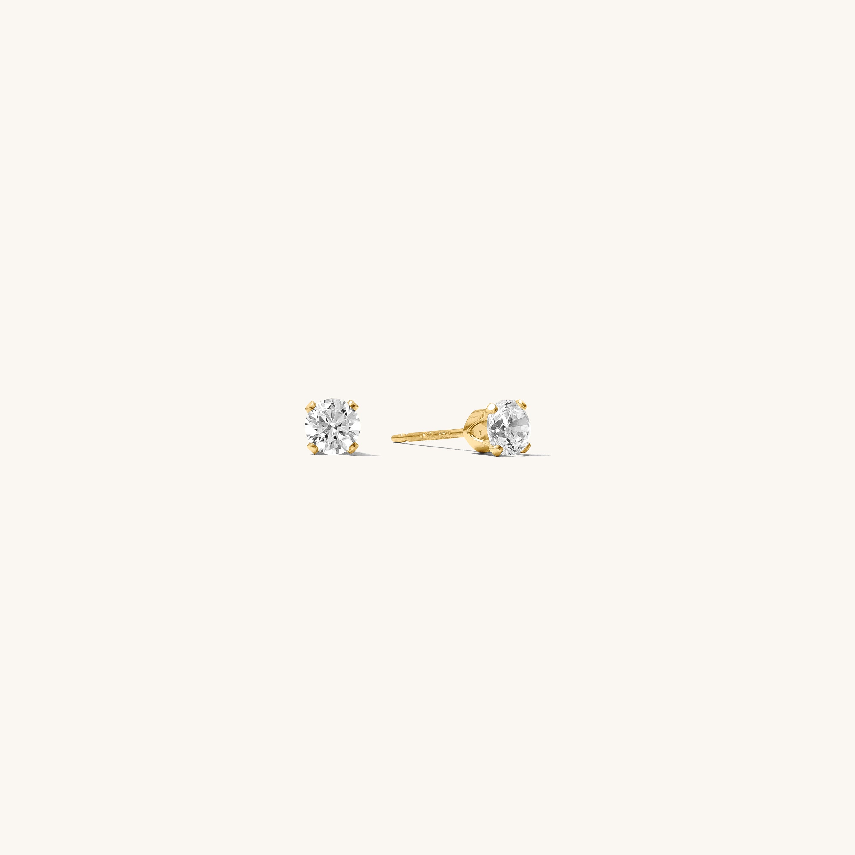 Close up of gold stone studs on a white background 