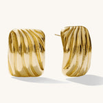 A pair of 14k gold plated, ridged and grooved design earrings, presented against a white background.