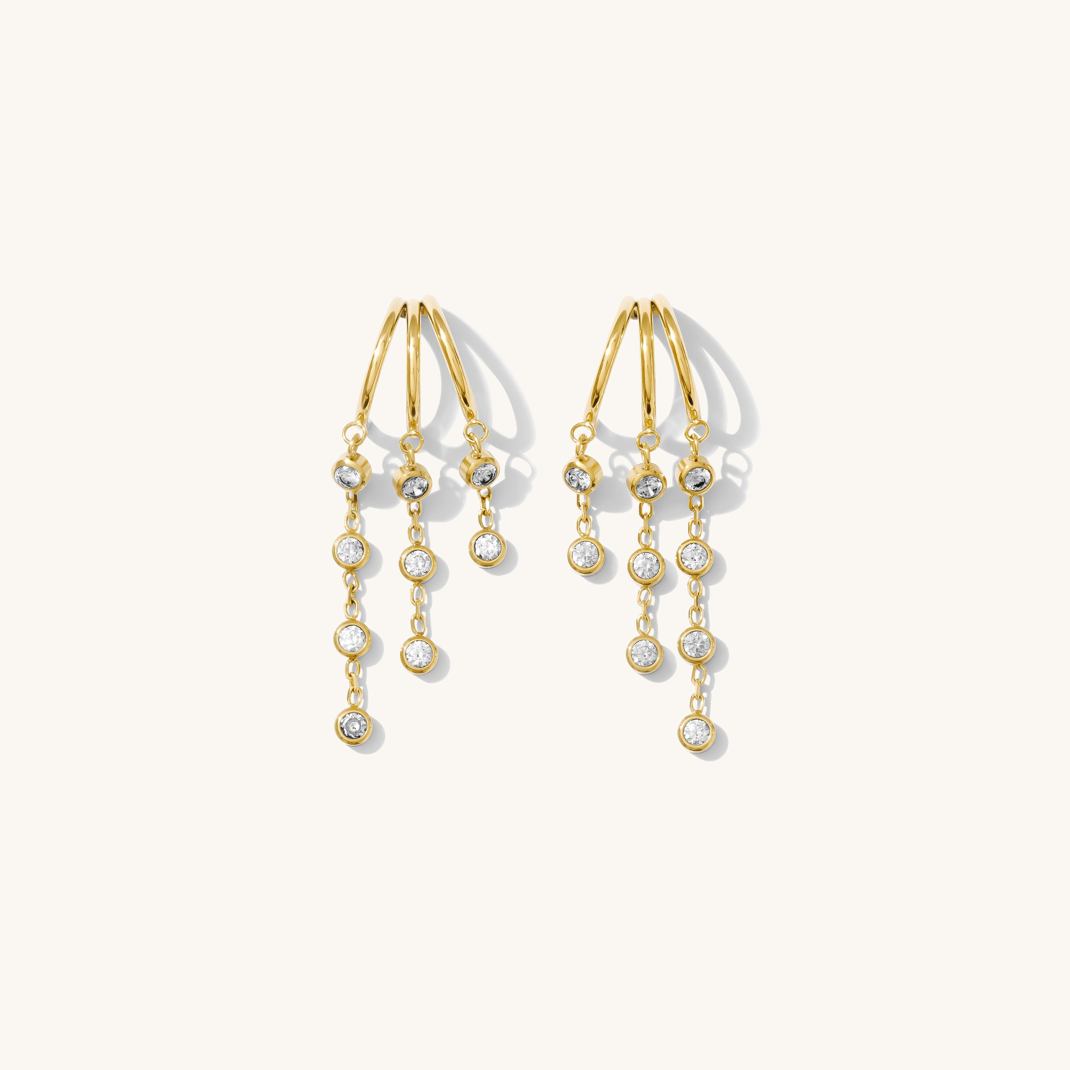 Close up of stone dangle earrings on a white background