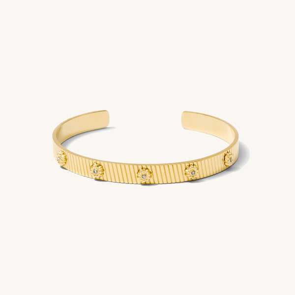 Gold textured cuff with flowers on a white background 