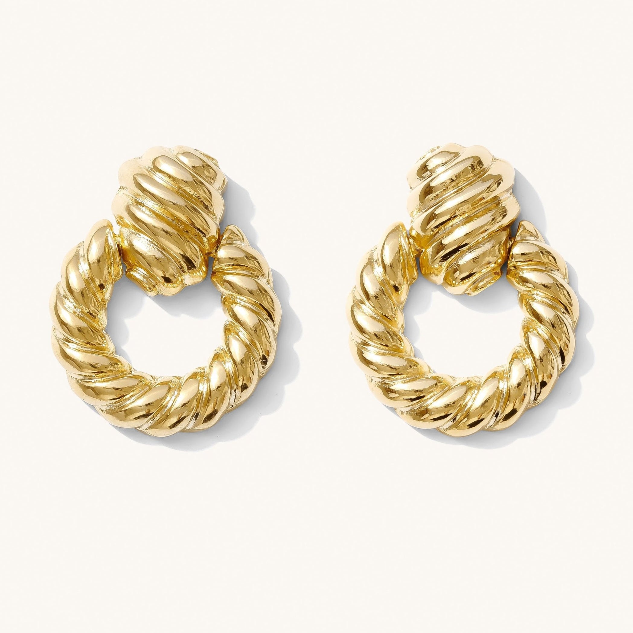 A pair of gold-plated duchess earrings with a twisted loop design.
