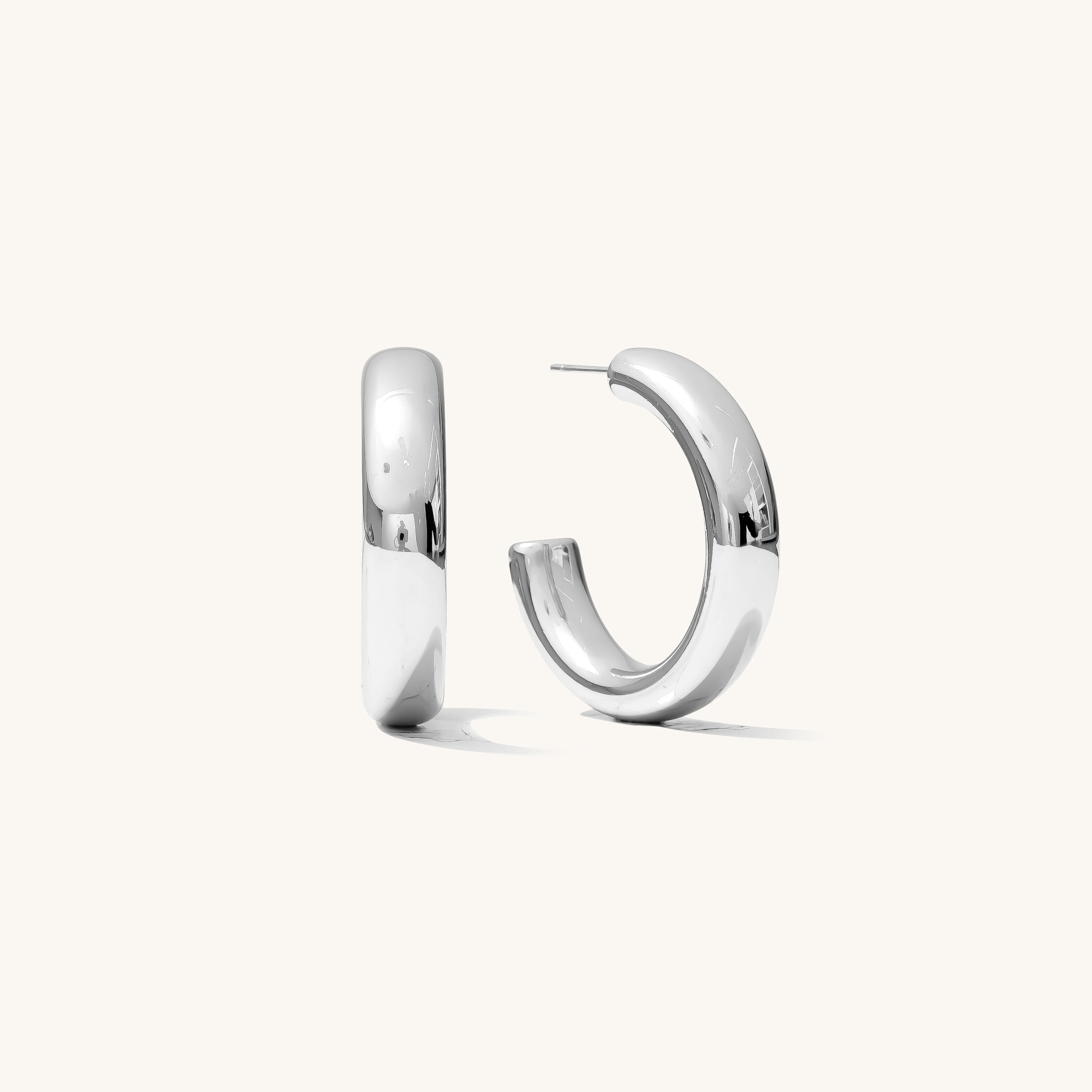 Close up of silver hoop earrings on a white background 