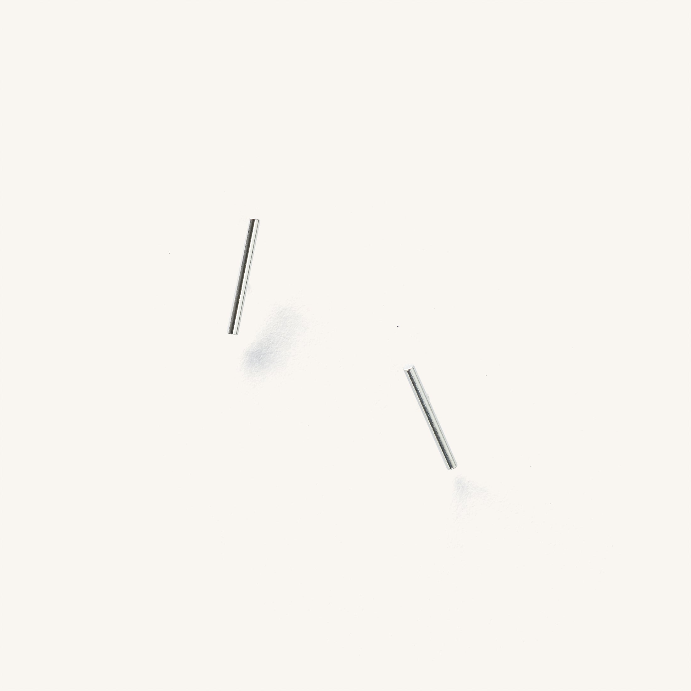 Close up of silver bar studs on a white background