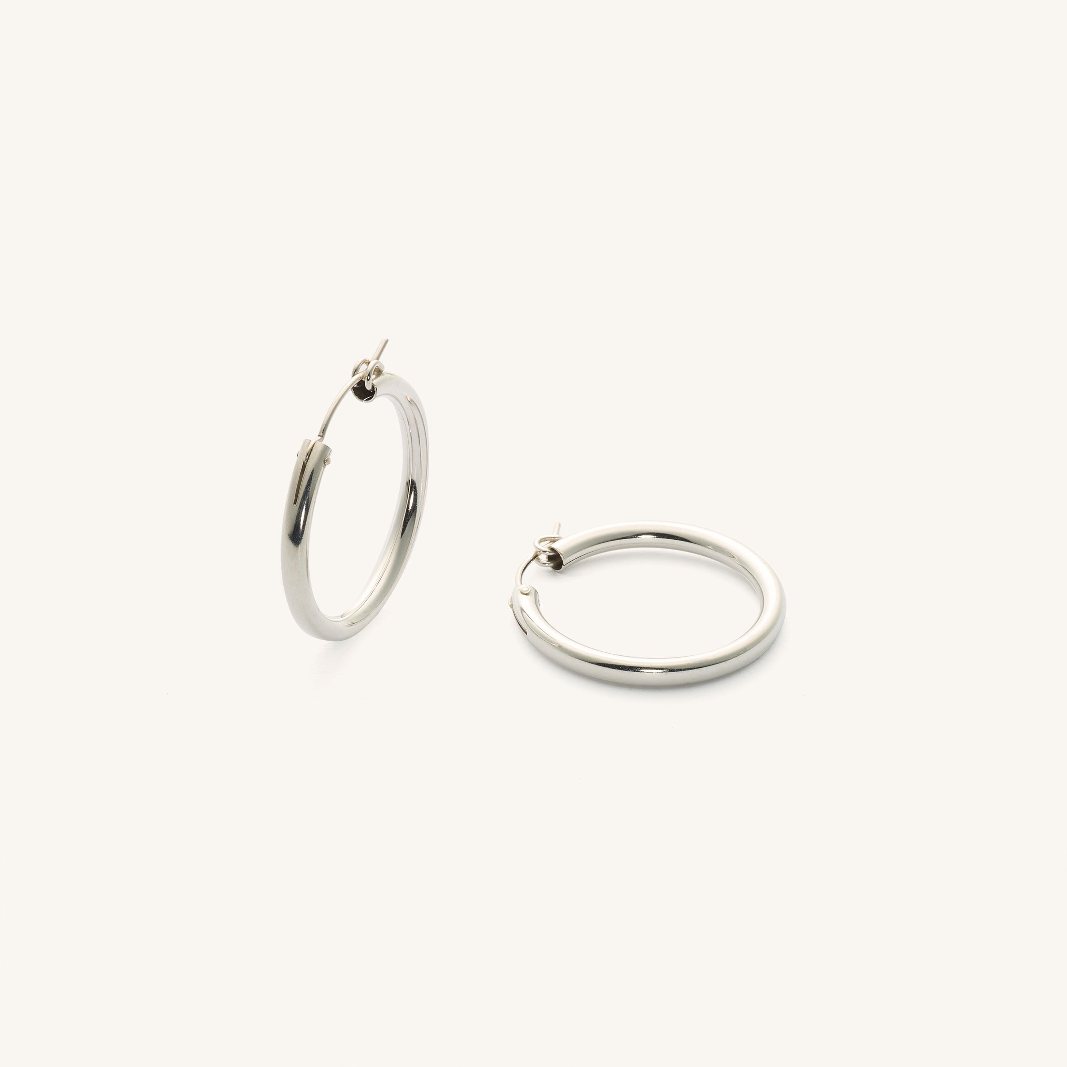 Close up of silver hoop earrings on a white background 